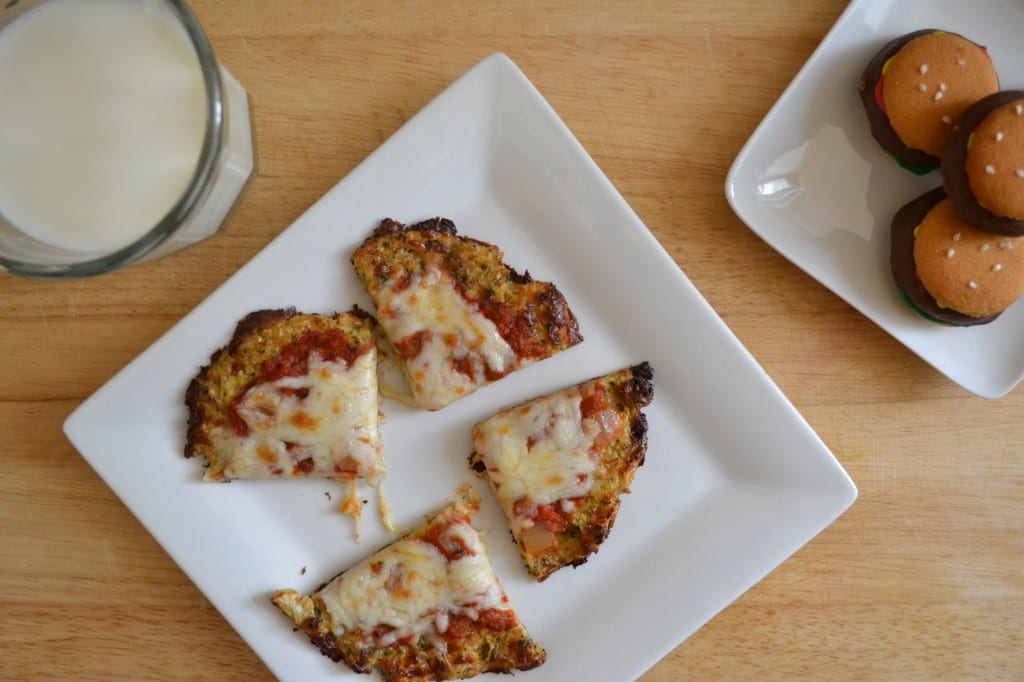 A plate with a sliced Cauliflower Crusted Pizza on it. 