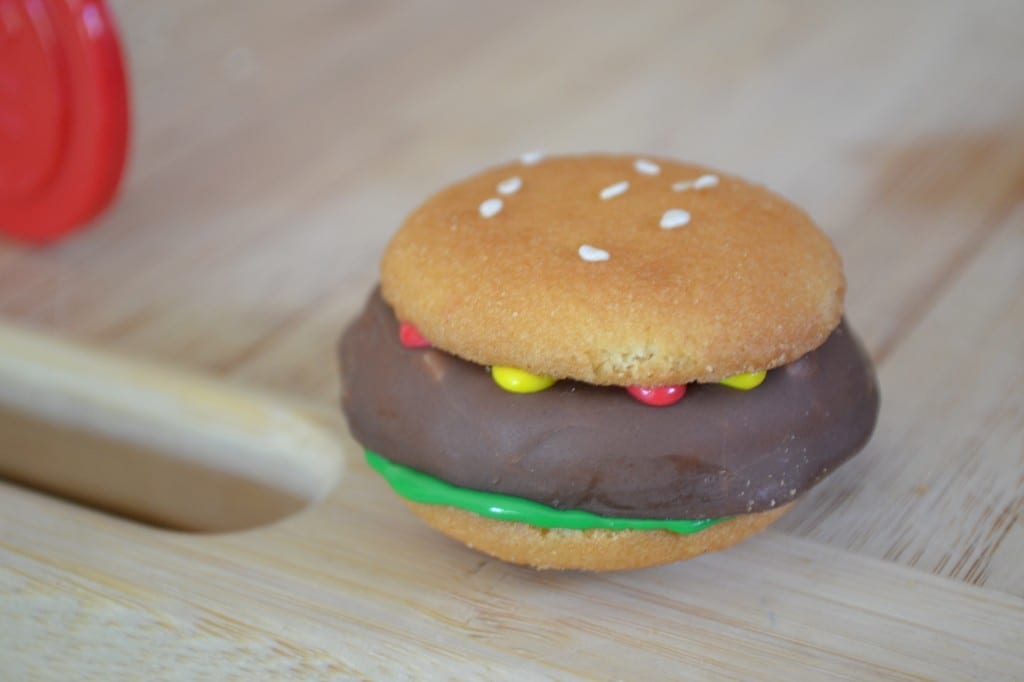 A hamburger cookie on a cutting board